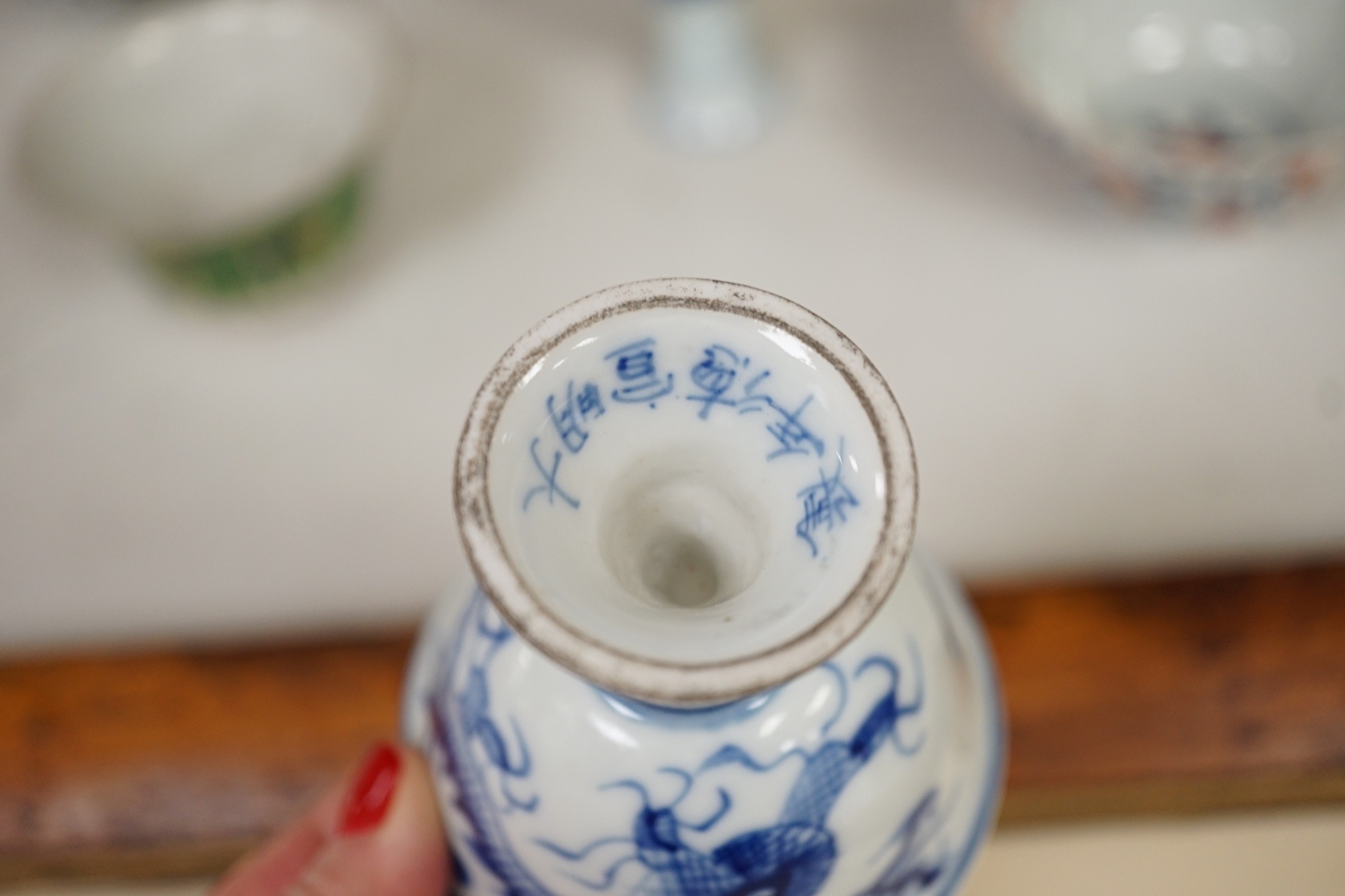 A Chinese wucai vase, two Imari bowls, a pair of Chinese blue and white dragon stem cups, Xuande marks, a Chinese blue and white dish, depicting a scholar on horseback, Xuande mark, a small green Chinese bowl, painted wi